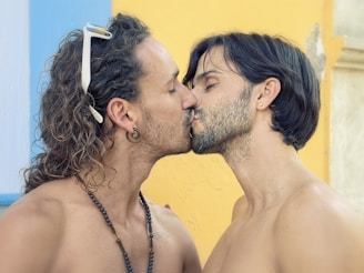 gay suagr daddy and sugar baby are kissing each other